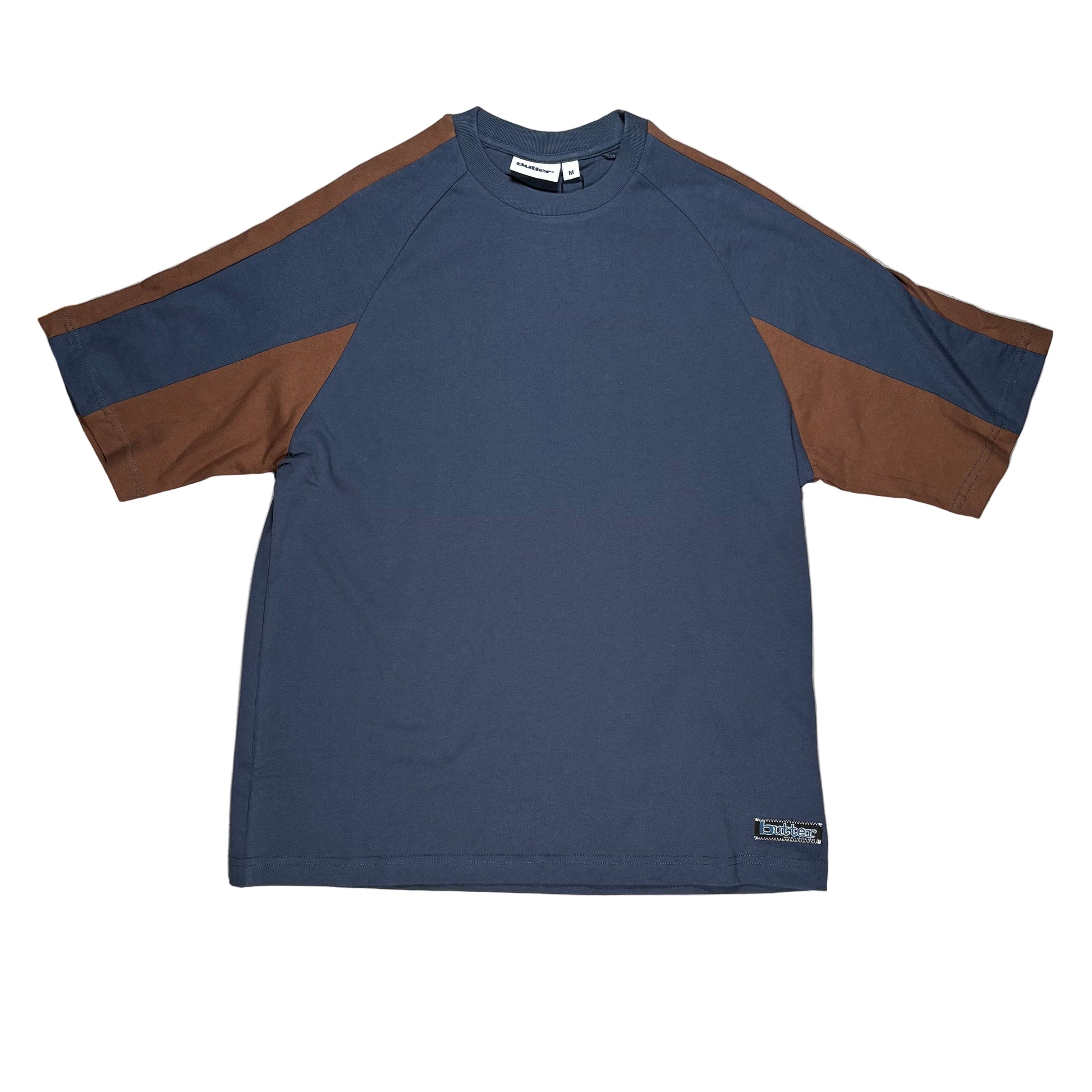 Blue and brown shirt on a white surface