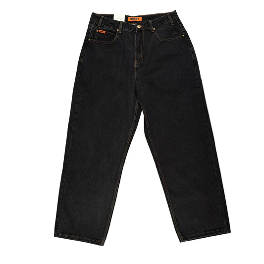 Black jeans on a gray surface with a white background