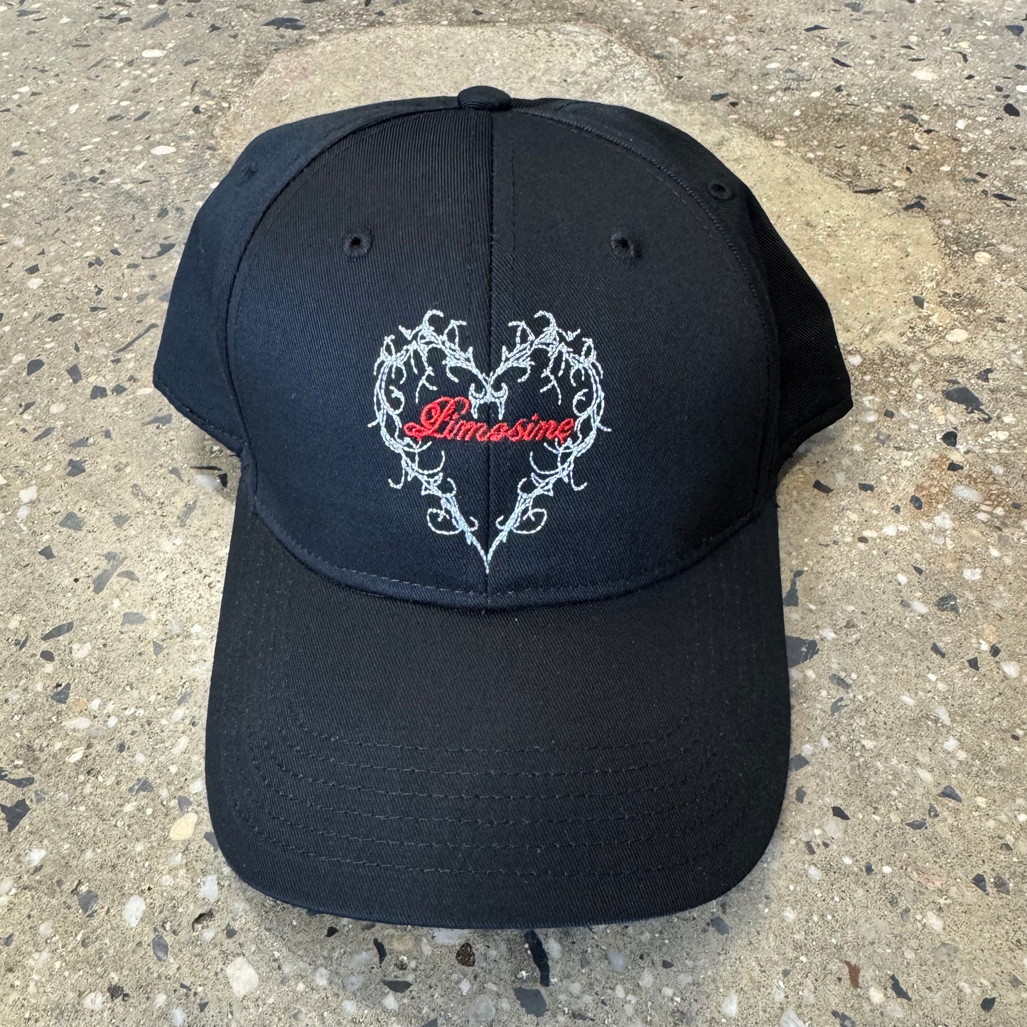 black hat with heart in the center