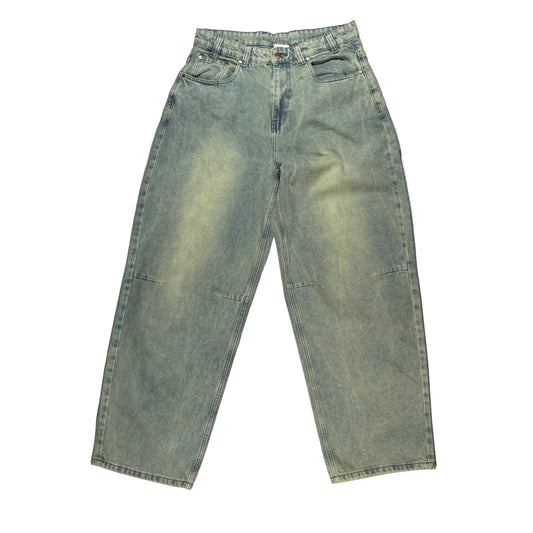 blue/Green jeans laid flat on a white surface 