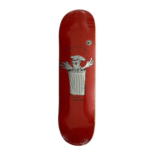 Red skateboard deck with a white graphic on a white surface