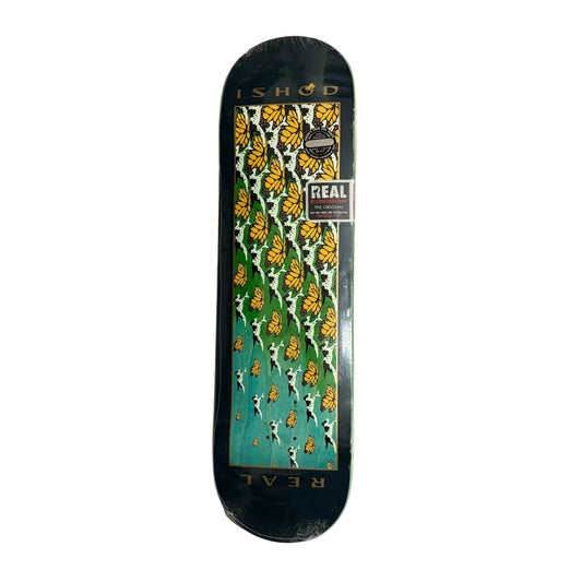 Skateboard deck with floral pattern and 'Real' branding on a gray surface.