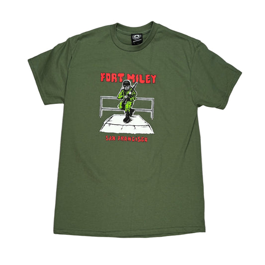 Green t-shirt with graphic design and text on a white surface