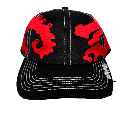 Black cap with red dragon designs on a white background