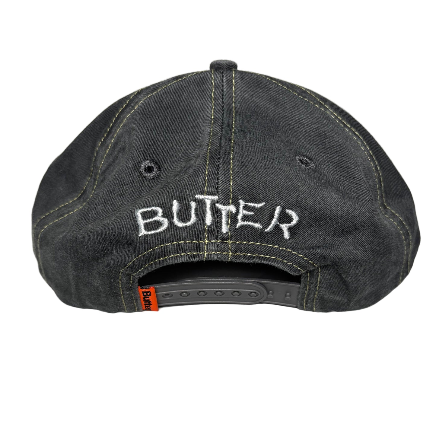 rear view of Black denim cap with 'Butter' branding on a light gray background