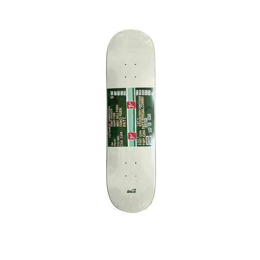 Skateboard deck with a green graphic on a gray surface