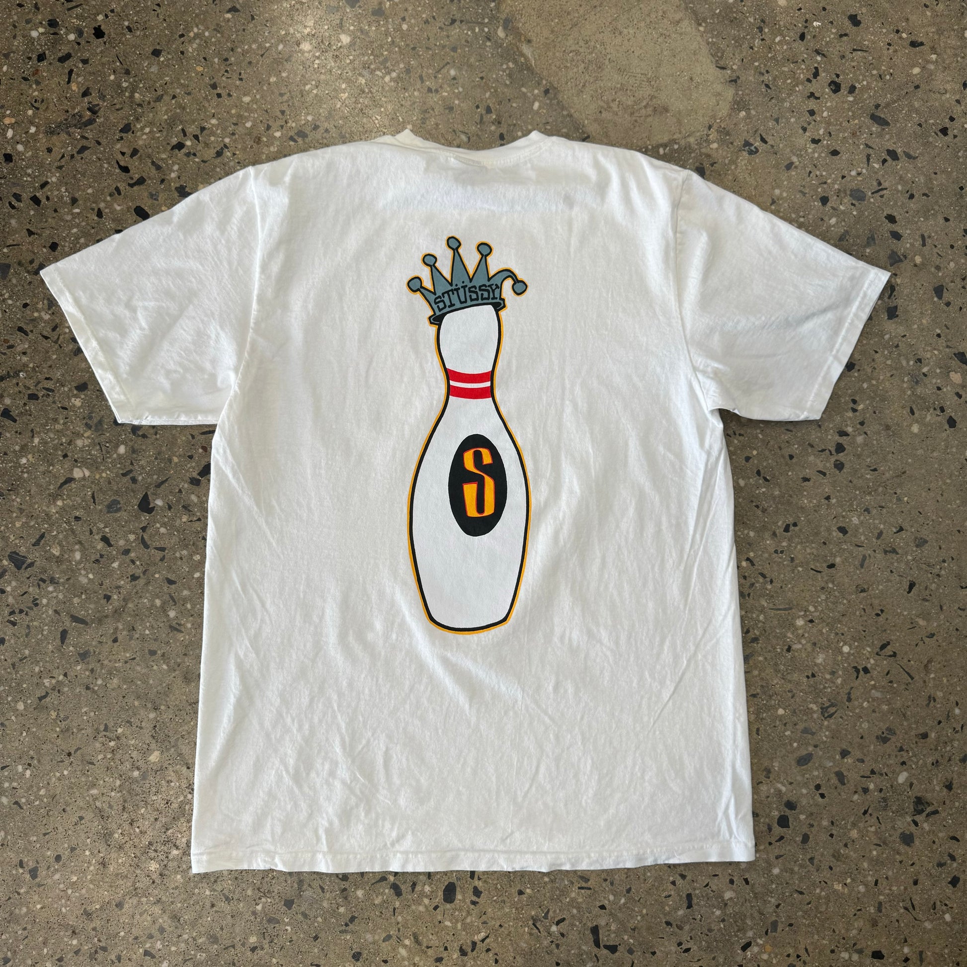 Rear view of t-shirt with bowling pin wearing a crown