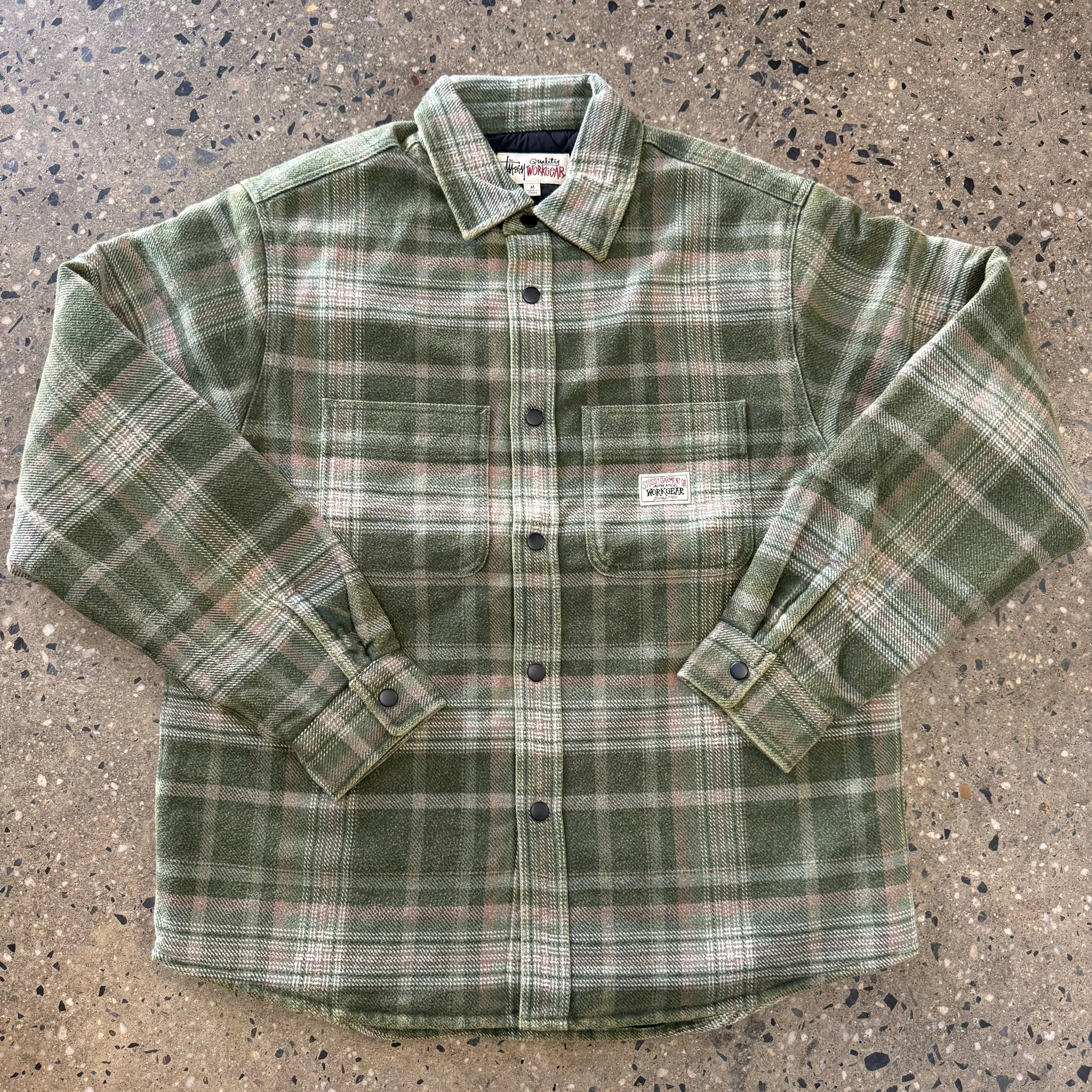 Front view of green plaid stussy quilted flannel