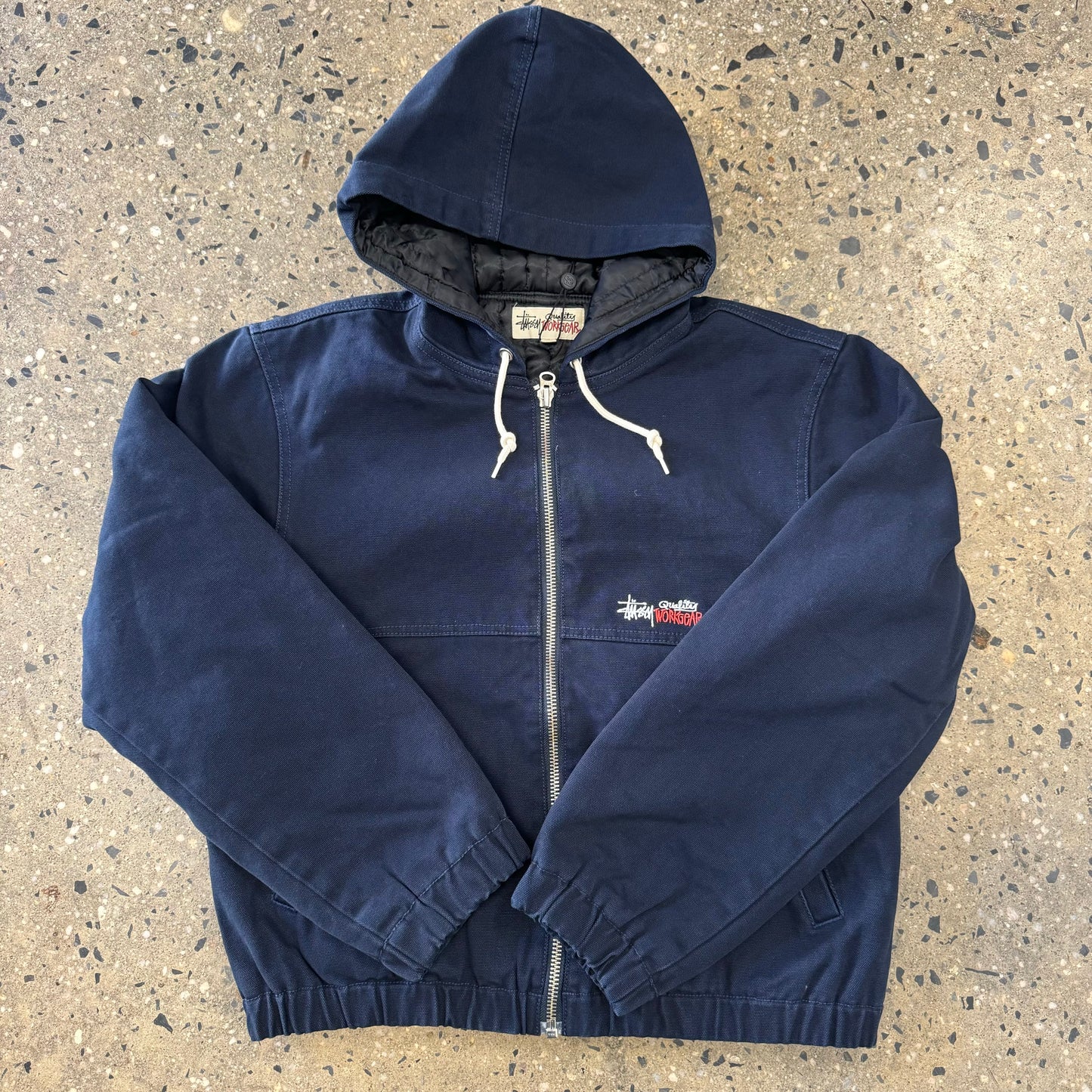 Front view of navy canvas work jacket from stussy