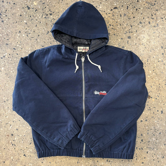 Front view of navy canvas work jacket from stussy