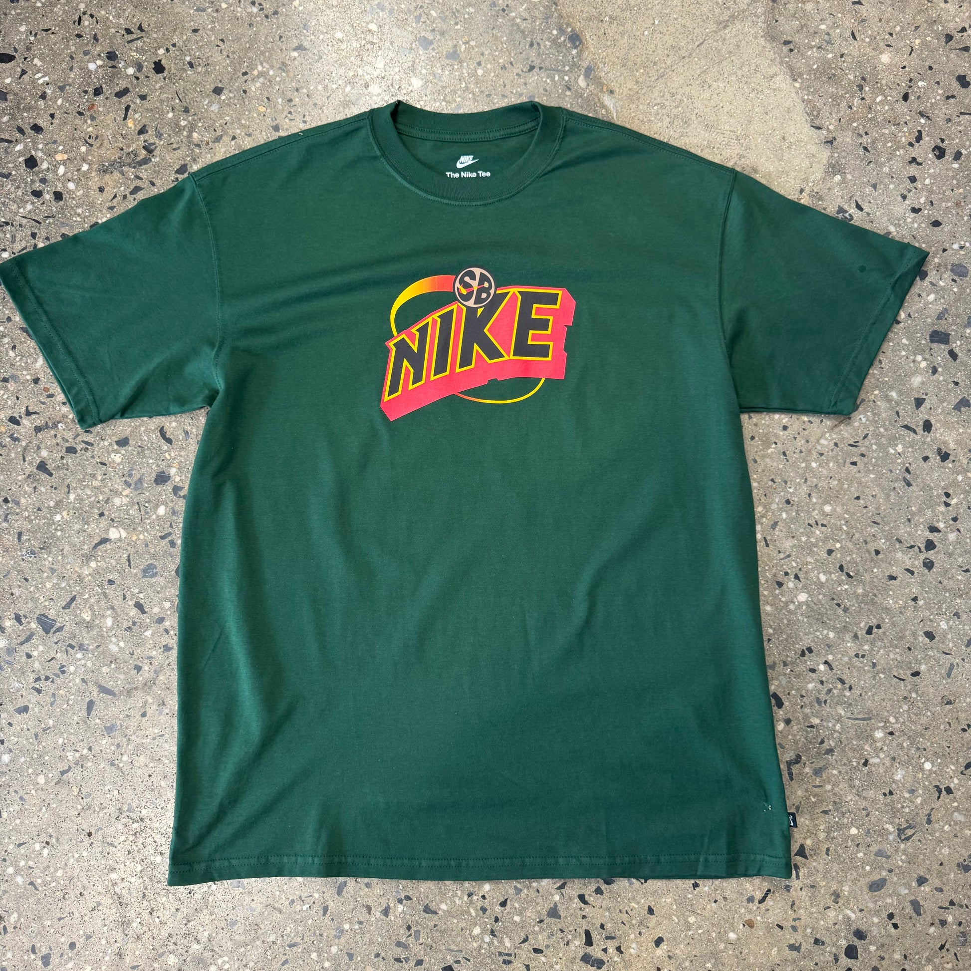 dark green t shirt with red yellow and black logo in the center