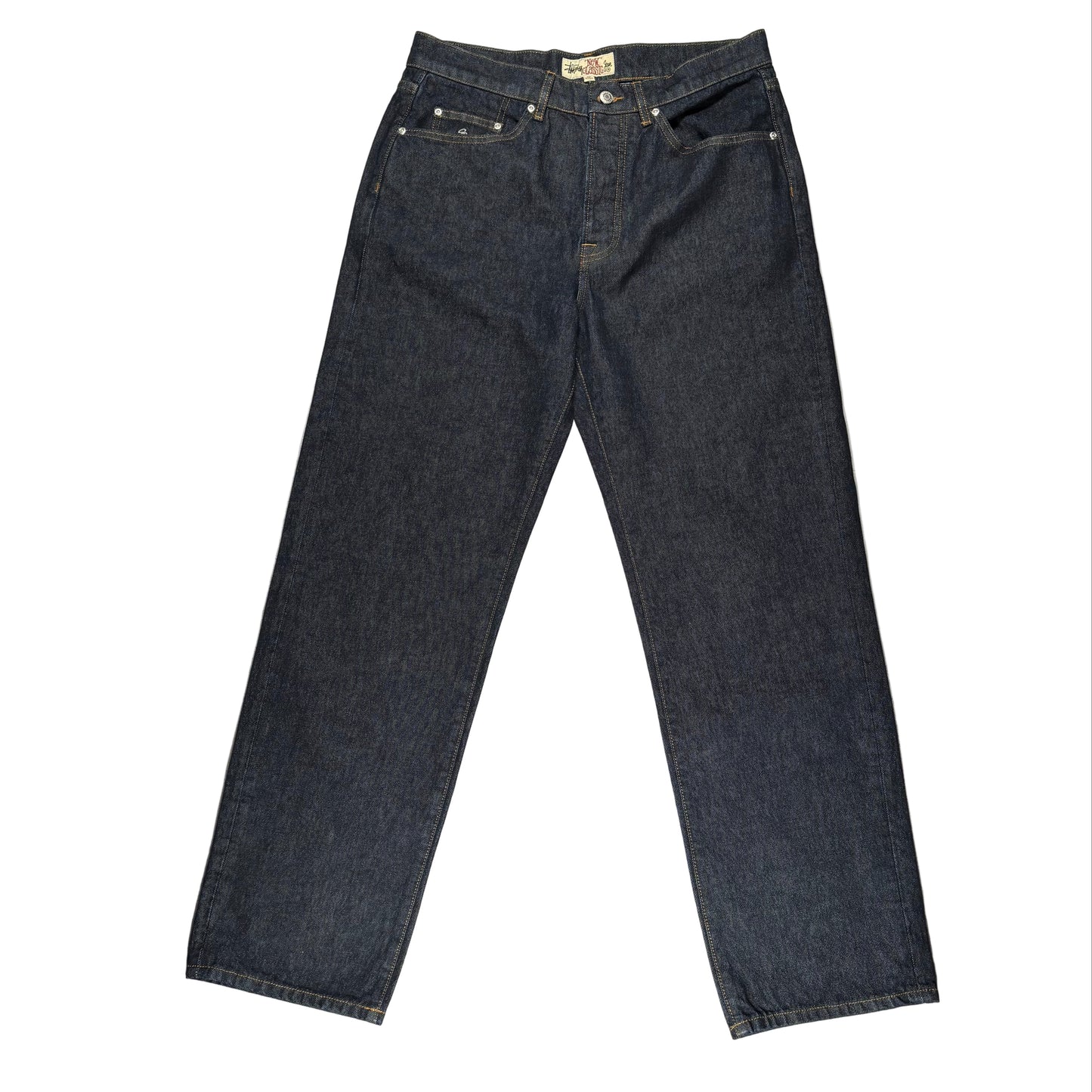 Pair of dark blue jeans on a white surface 