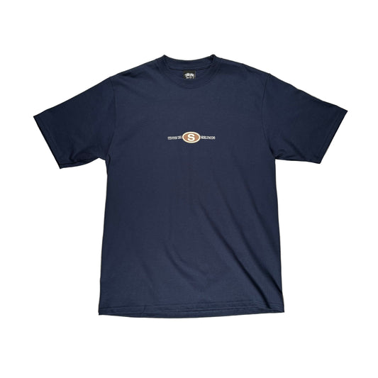Navy blue t-shirt with a stussy logo on a white surface