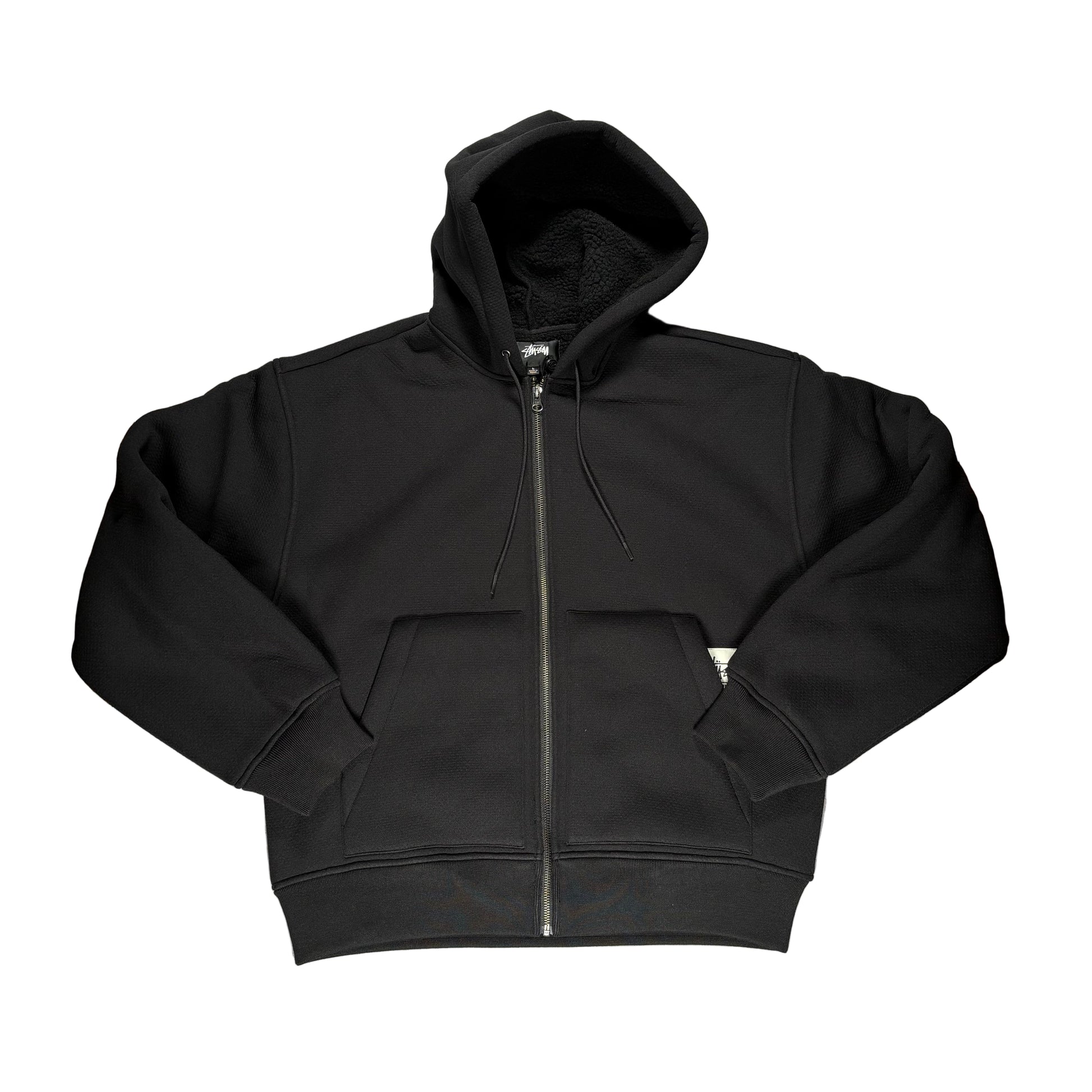 Black hoodie with a zipper on a white surface
