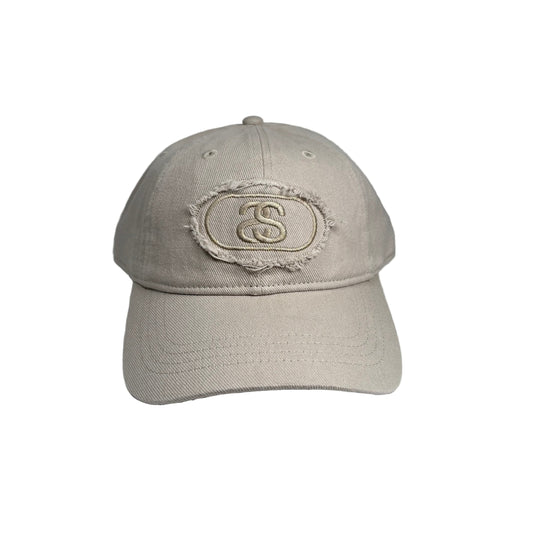 Beige cap with a logo on a white  background