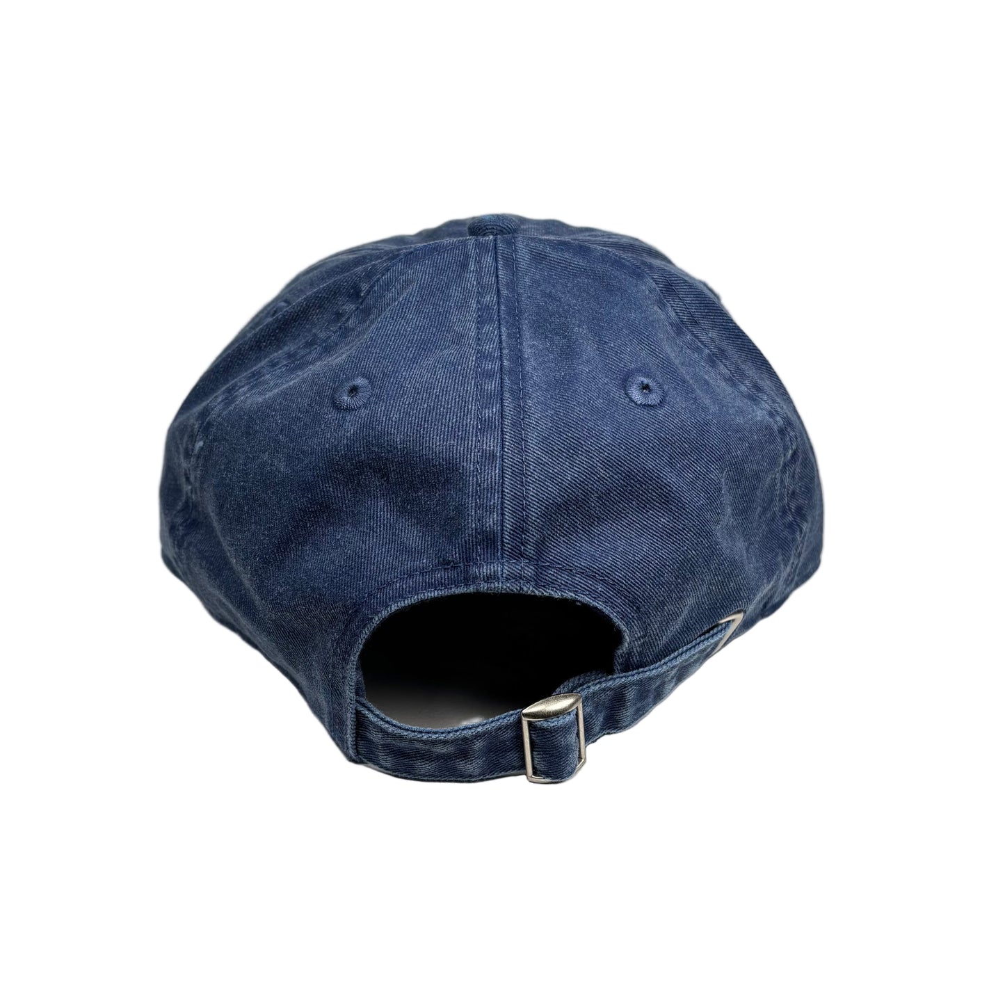 Blue denim cap on a white surface 
