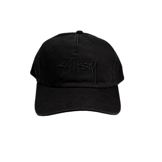 Black cap with a tonal black stusst logo on a white background