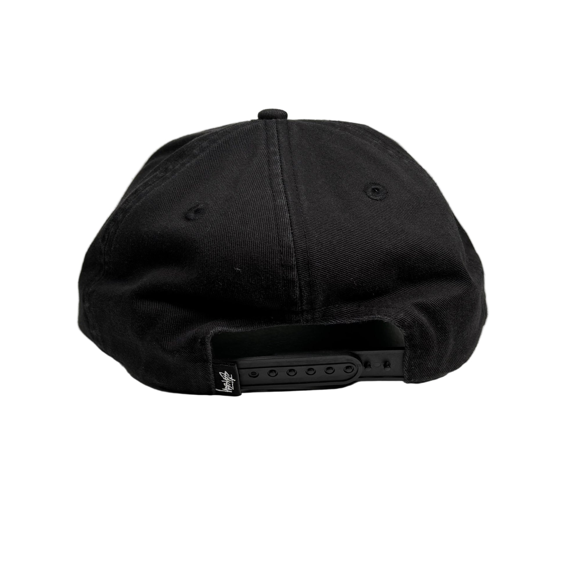 Black cap on a white surface 