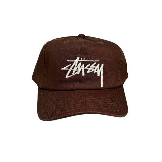 Brown cap with white stussy logo on a white background