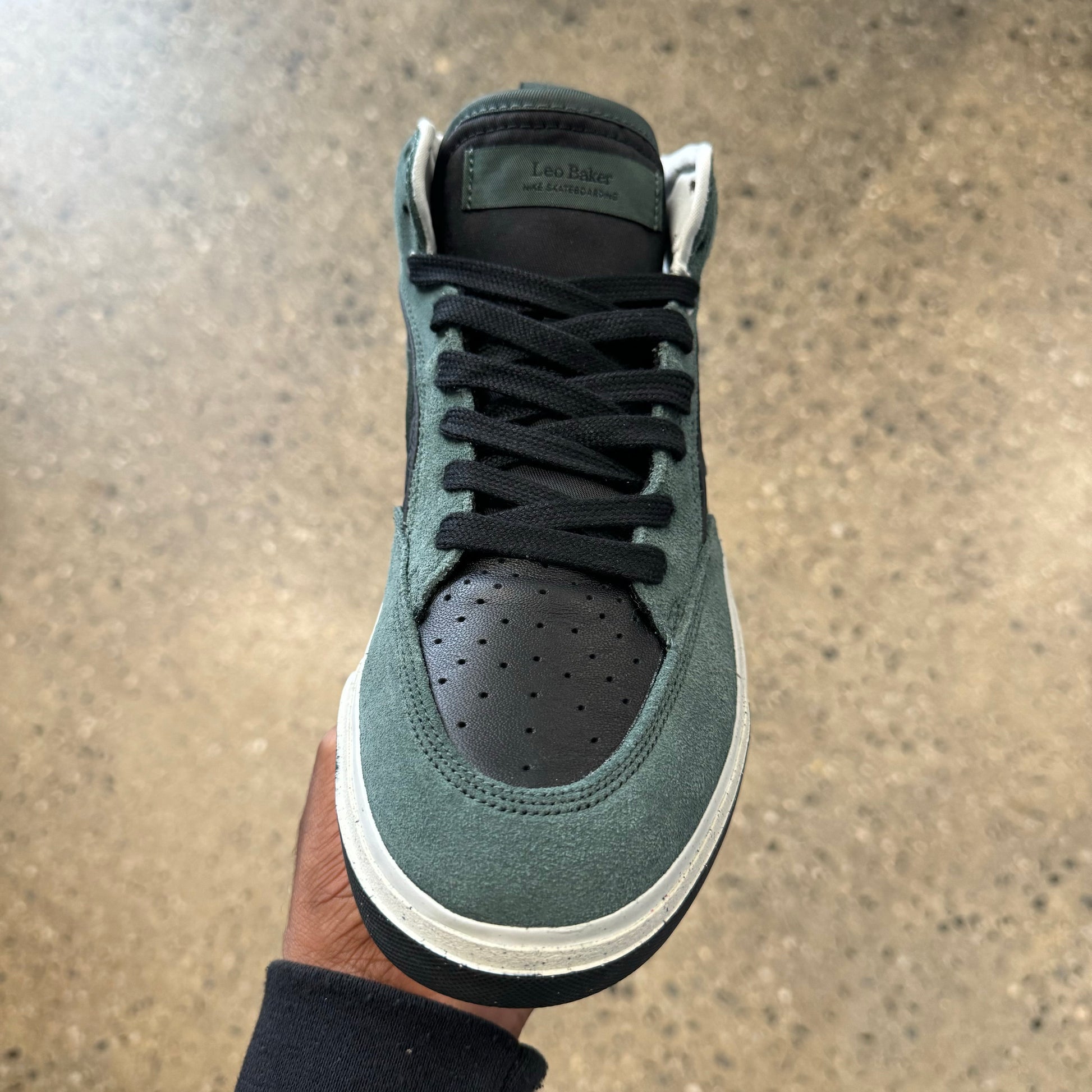 mid top shoe with green suede and black leather