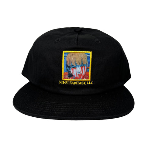 Black cap with embroidered design and text on a white surface