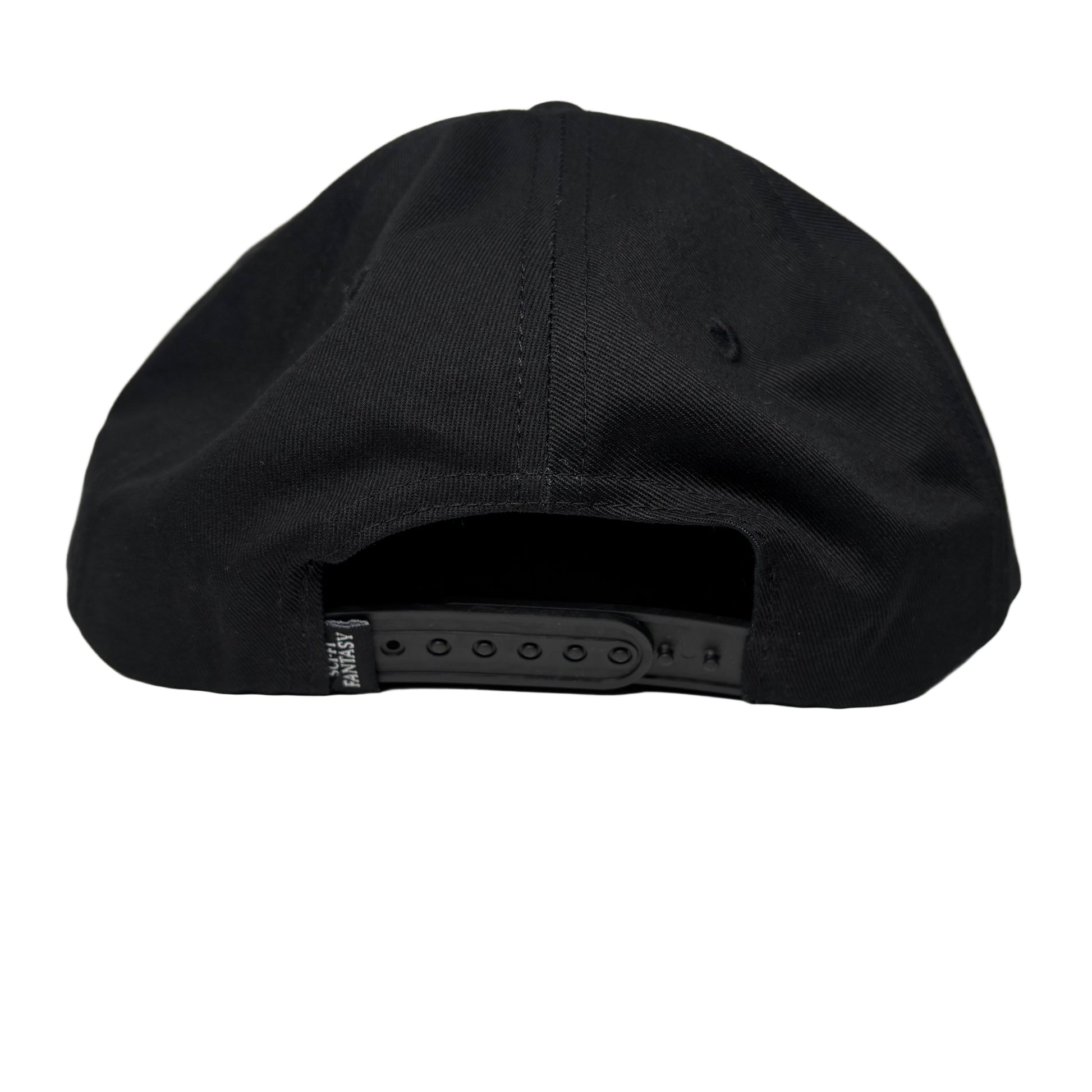 Black cap on a white surface with a gray background