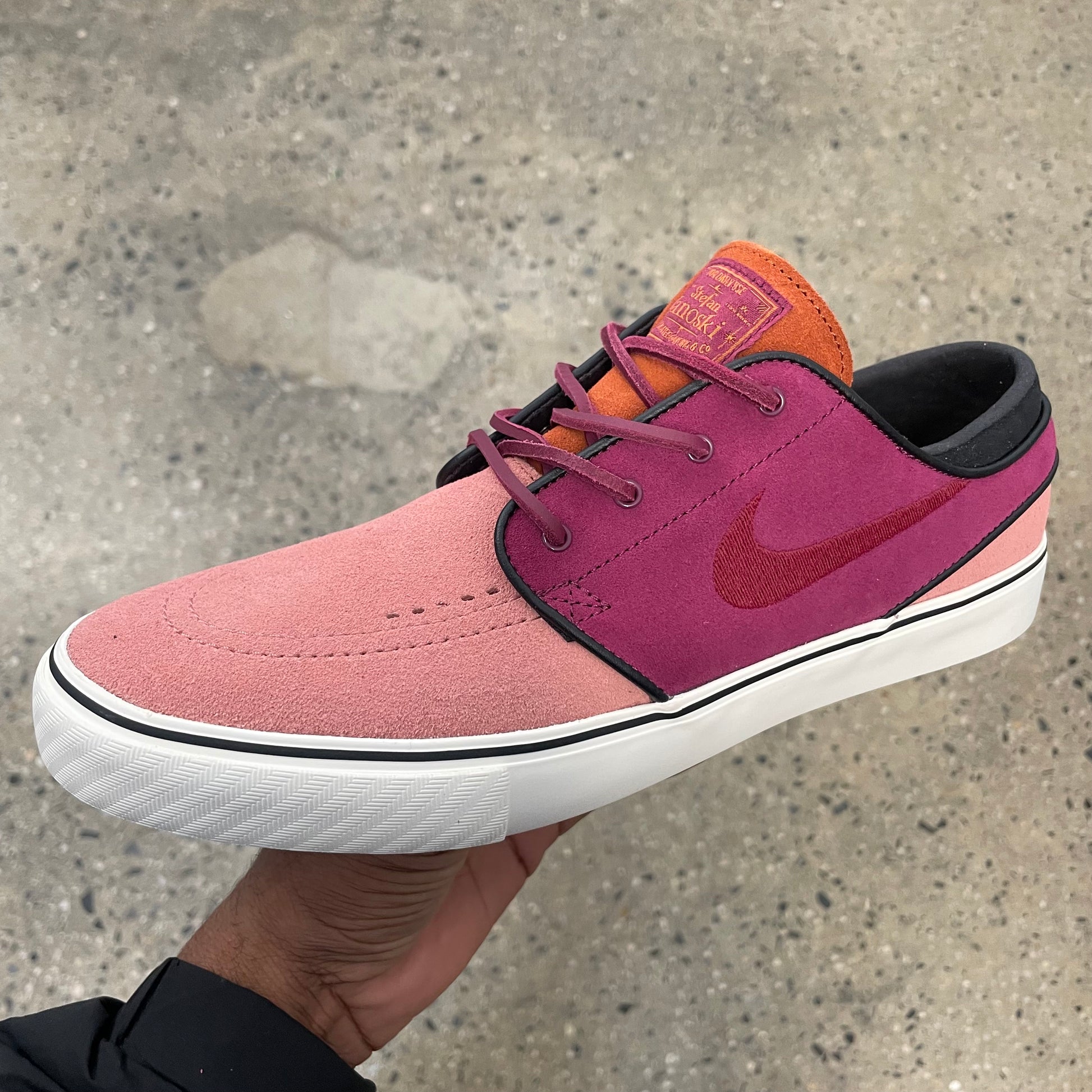 dual tone pink suede low top sneaker with white sole, side view