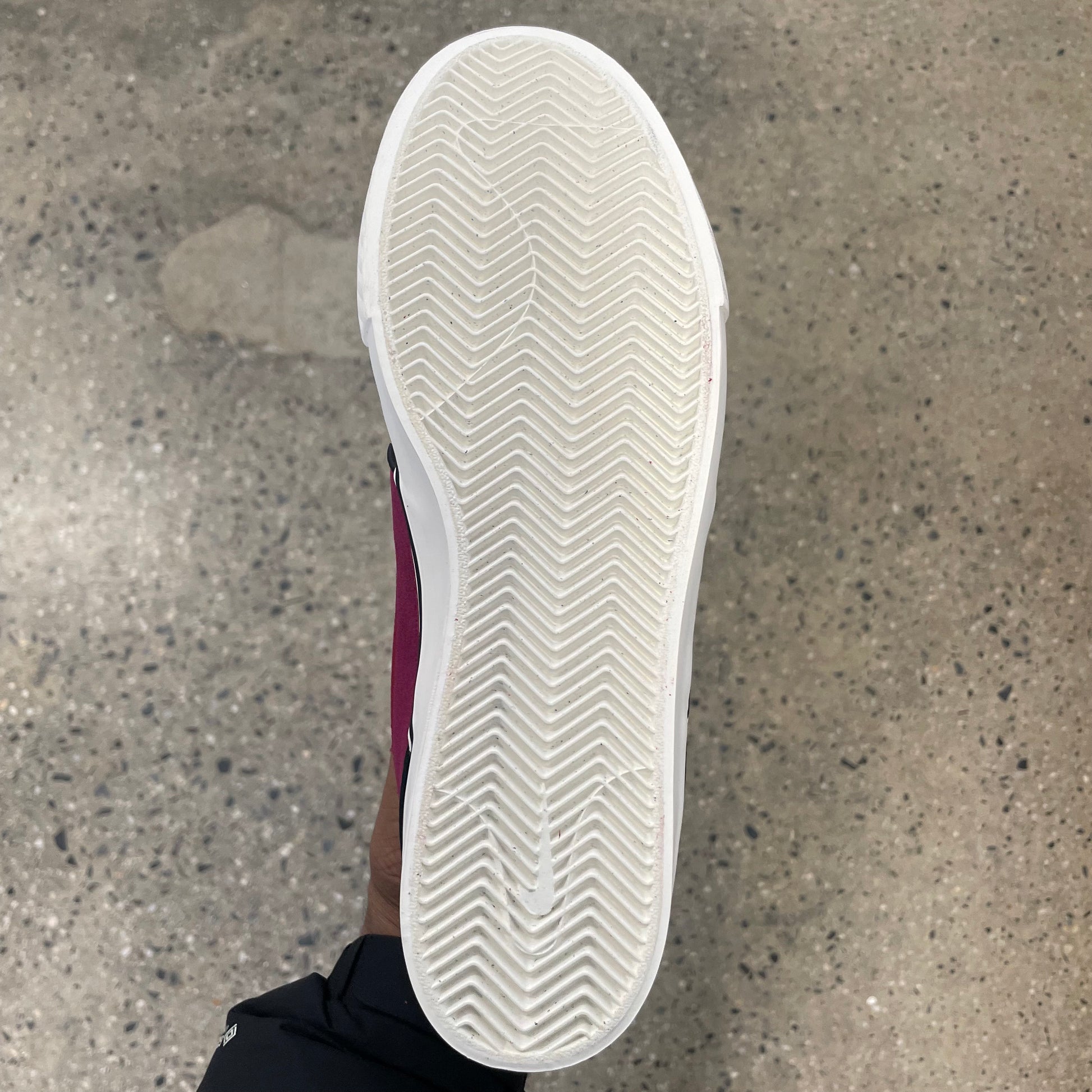view of white outsole on suede sneaker