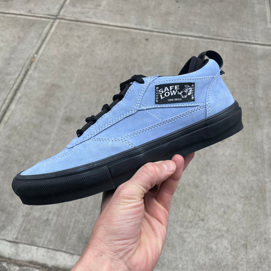 side view of blue suede low top skateboard shoe with black outsole