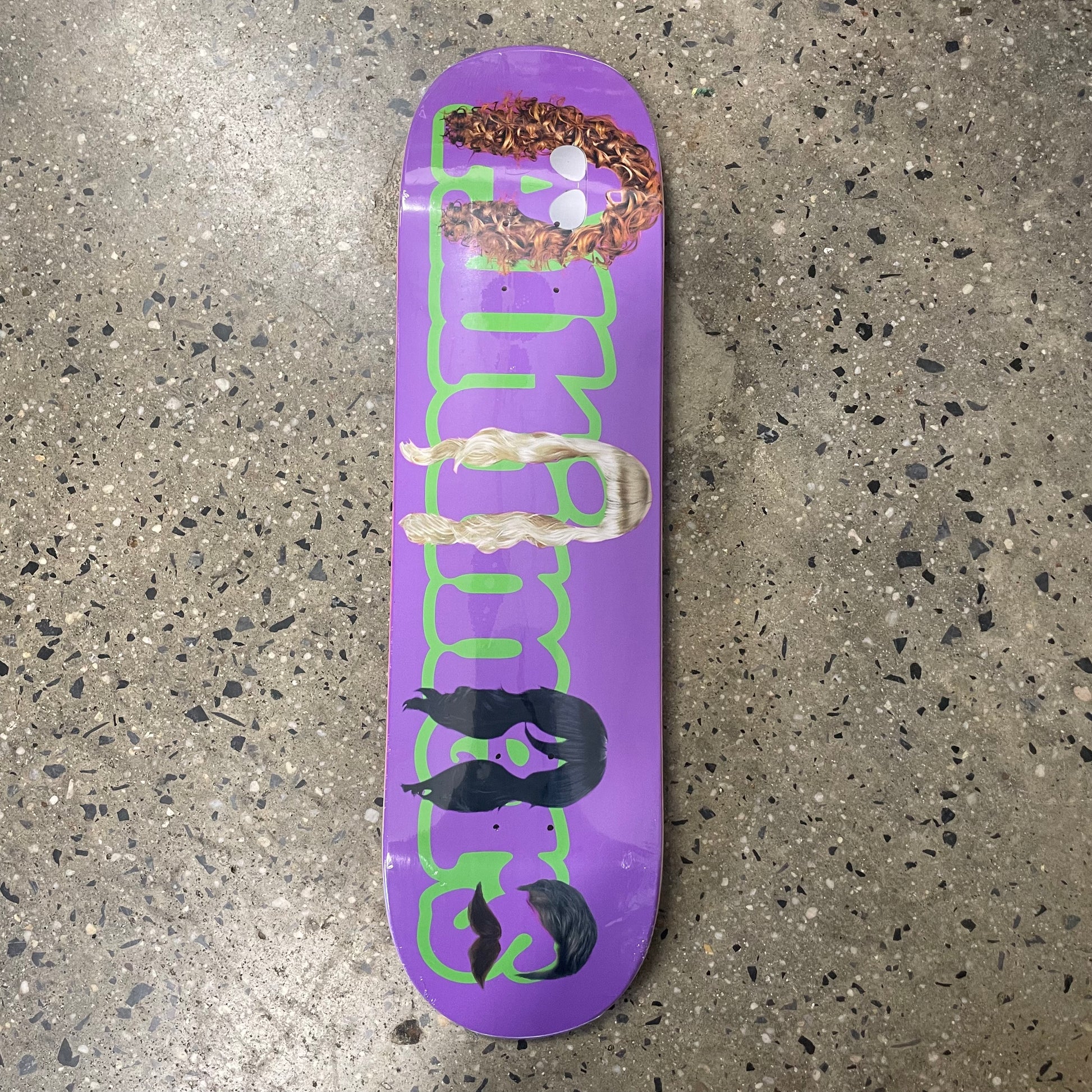 alltimers logo in green on purple skate deck, brown wig on A, blonde wig on i, Black wig on e, dark brown wig and mustache on s