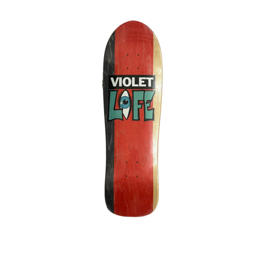Skateboard deck with 'Violet Life' logo on a white surface
