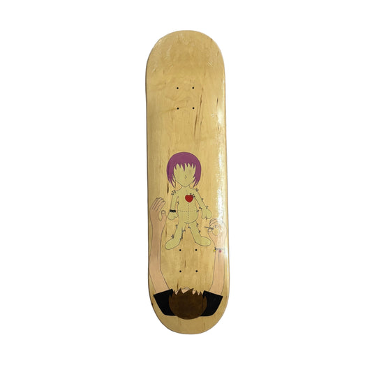 Skateboard deck with a character design on a white surface