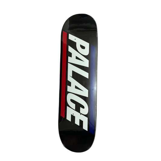 Skateboard deck with 'PALACE' logo on a white surface
