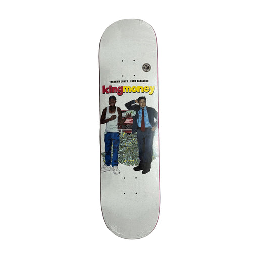 Skateboard deck with 'king money' branding and images of two people on a white surface.