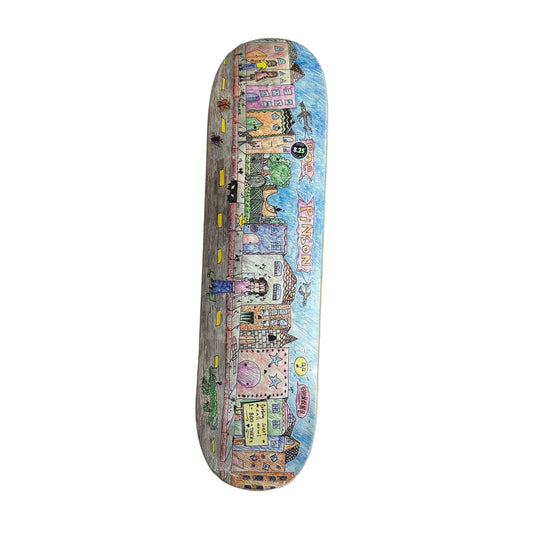Skateboard deck with a colorful cityscape design on a white surface
