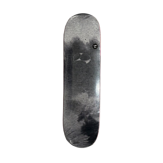 Skateboard deck with a black and white design on a white surface
