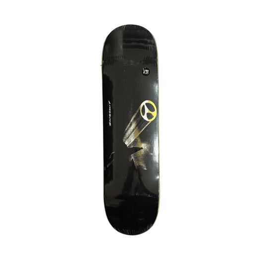 Black skateboard deck with a yellow logo on a white surface