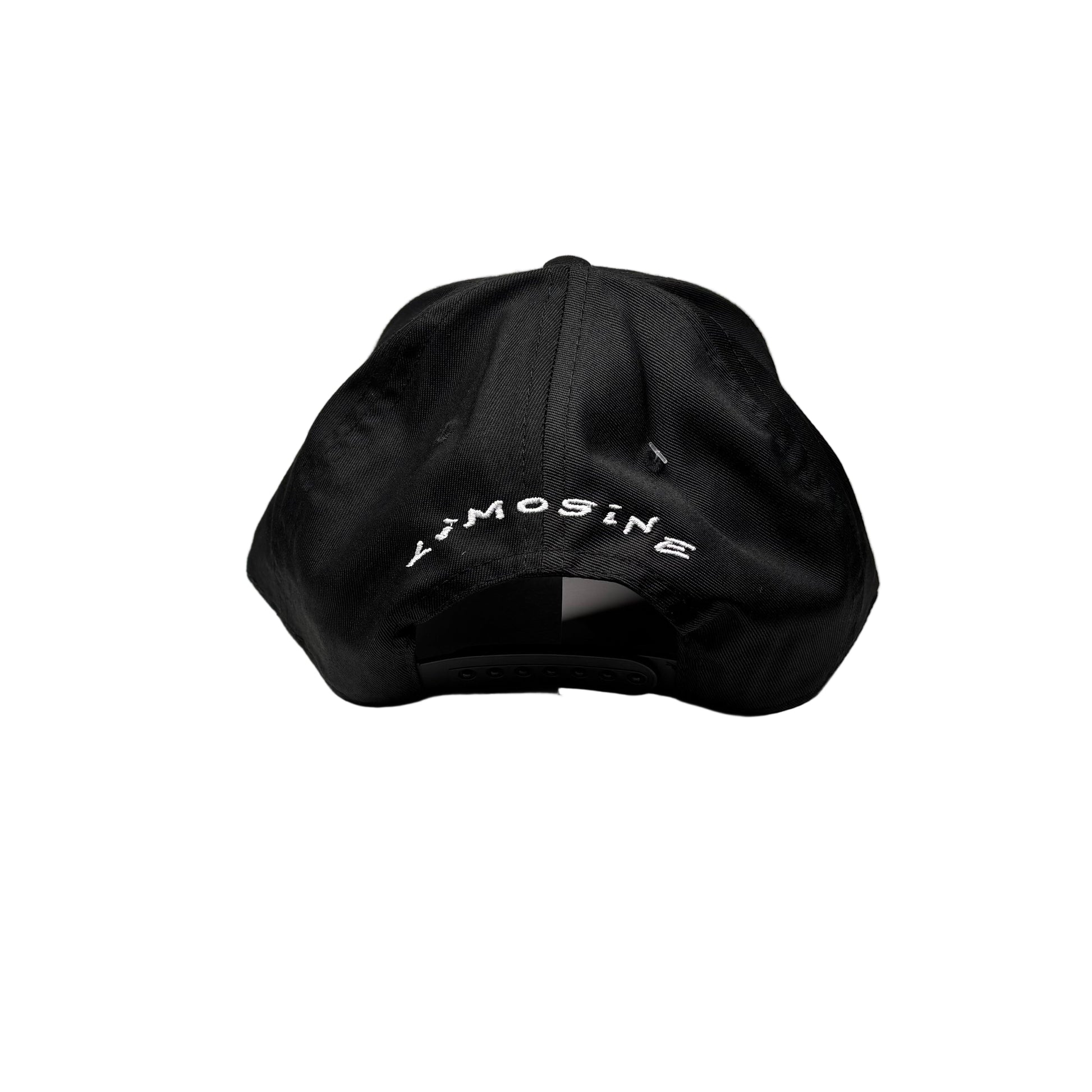 Black cap with white text on a white pedestal against a gray background