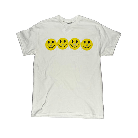 White t-shirt with yellow smiley face graphics on a white surface