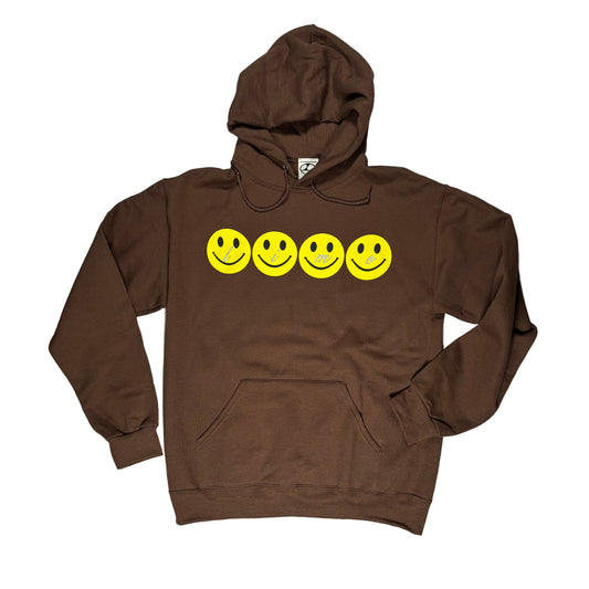 Brown hoodie with yellow smiley faces on a white surface