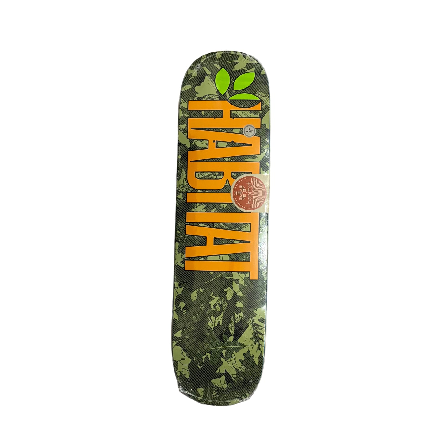 Skateboard deck with green leaf pattern and orange text on a white surface