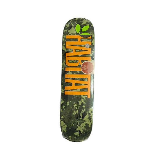Skateboard deck with green leaf pattern and orange text on a white surface