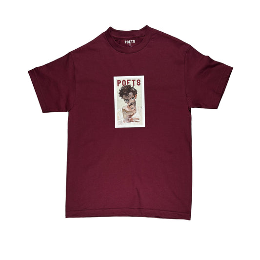 Maroon t-shirt with graphic design on a white surface