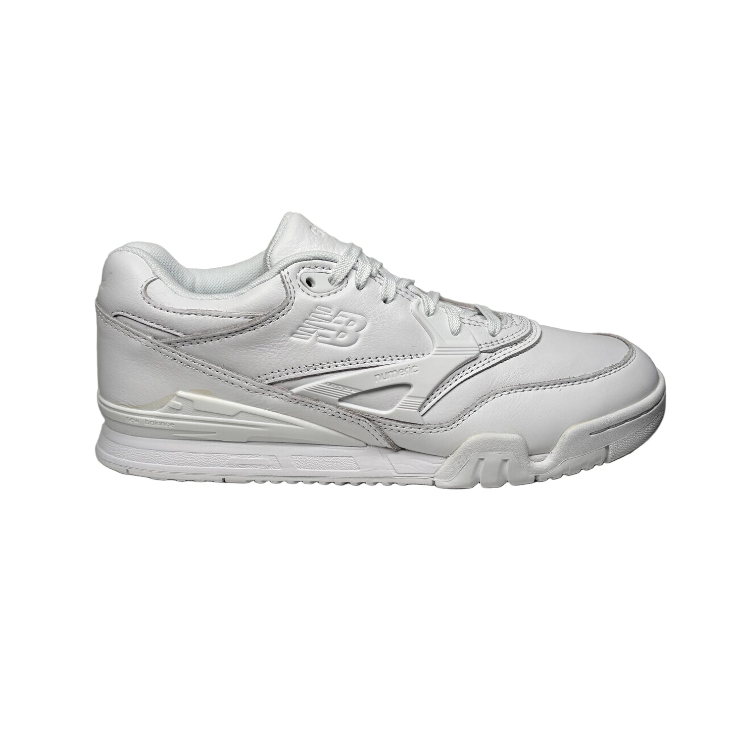 White new balance sneaker leaning against a white wall