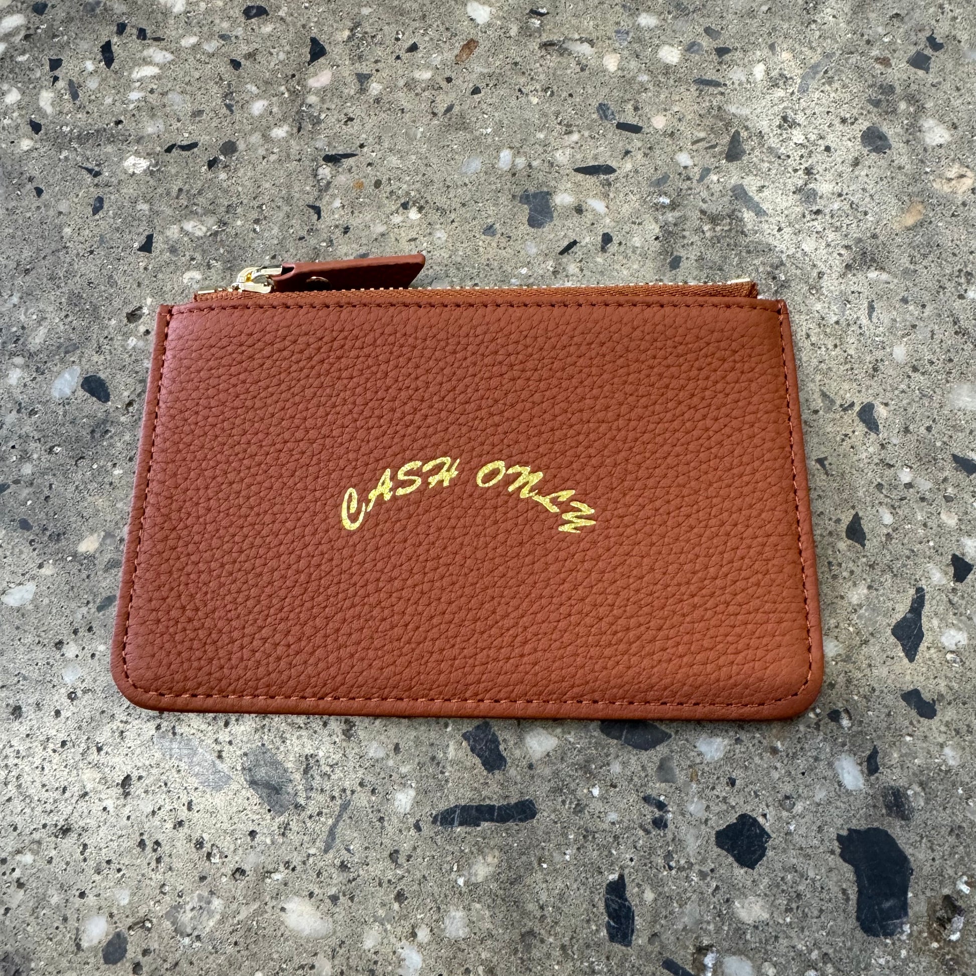 Gold cash only logo stamped on center of leather zip wallet