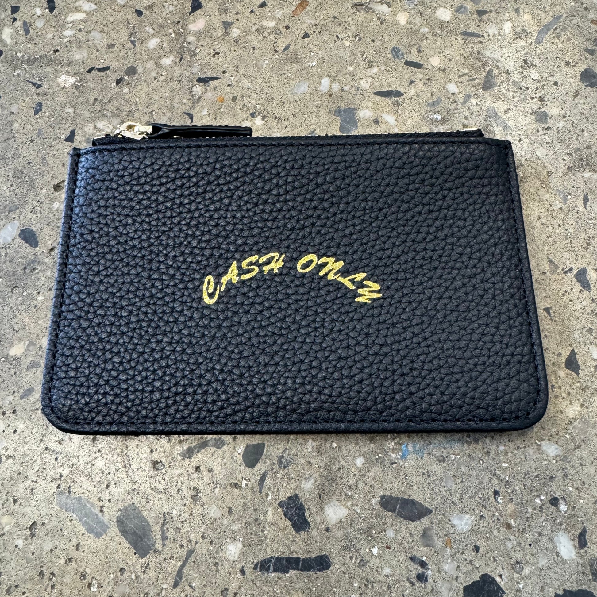 gold stamped cash only logo on middle of leather zip wallet