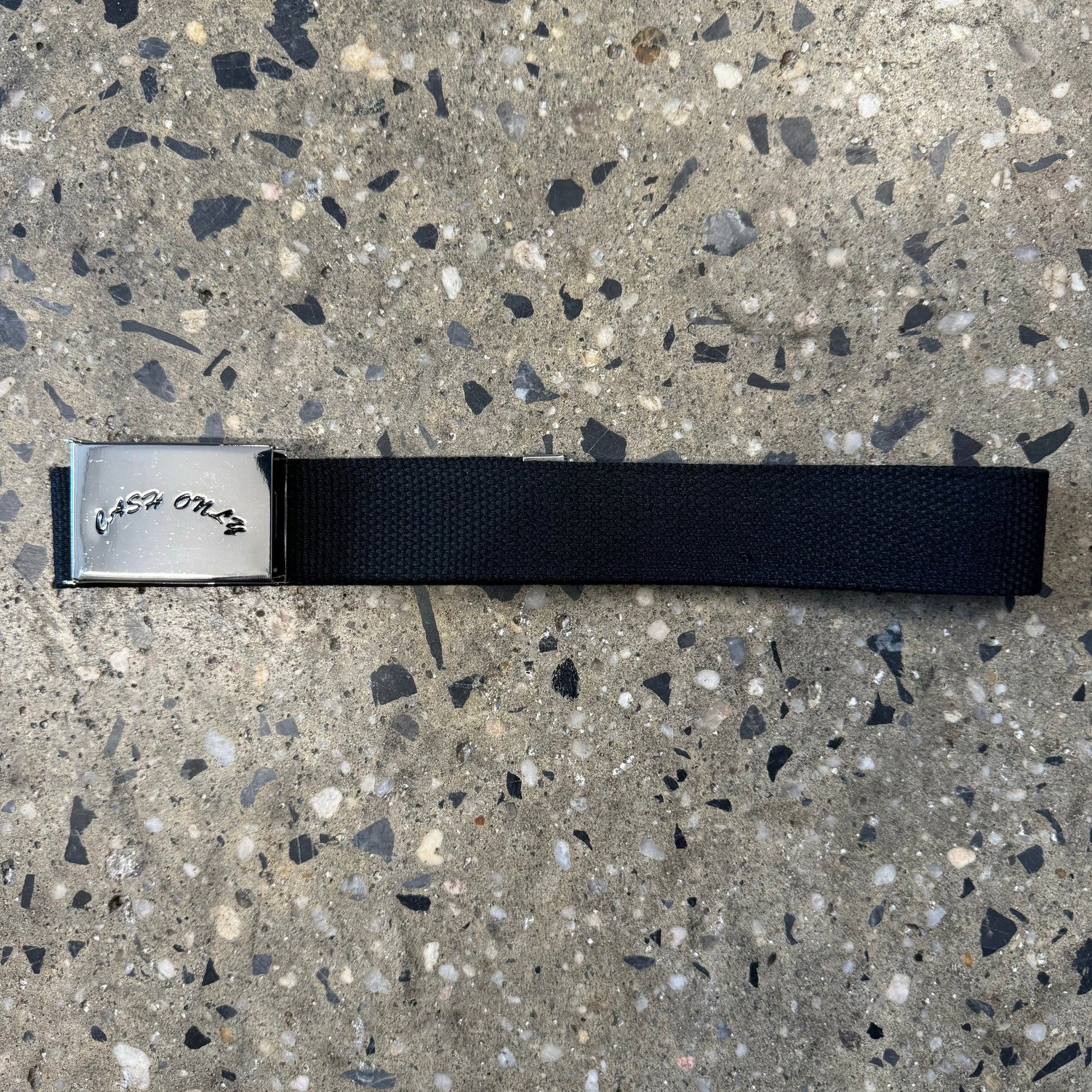black cash only arch logo stamped on silver metal belt buckle, black webbed belt