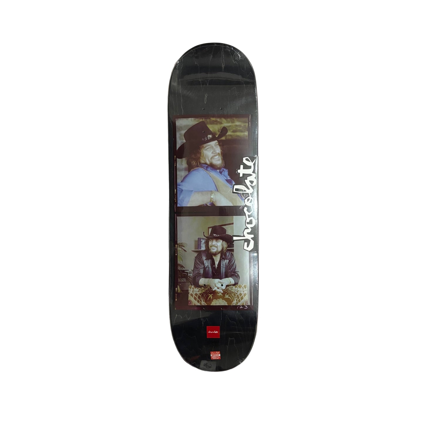 Skateboard deck with a cowboy graphic and 'Chocolate' branding on a white surface.