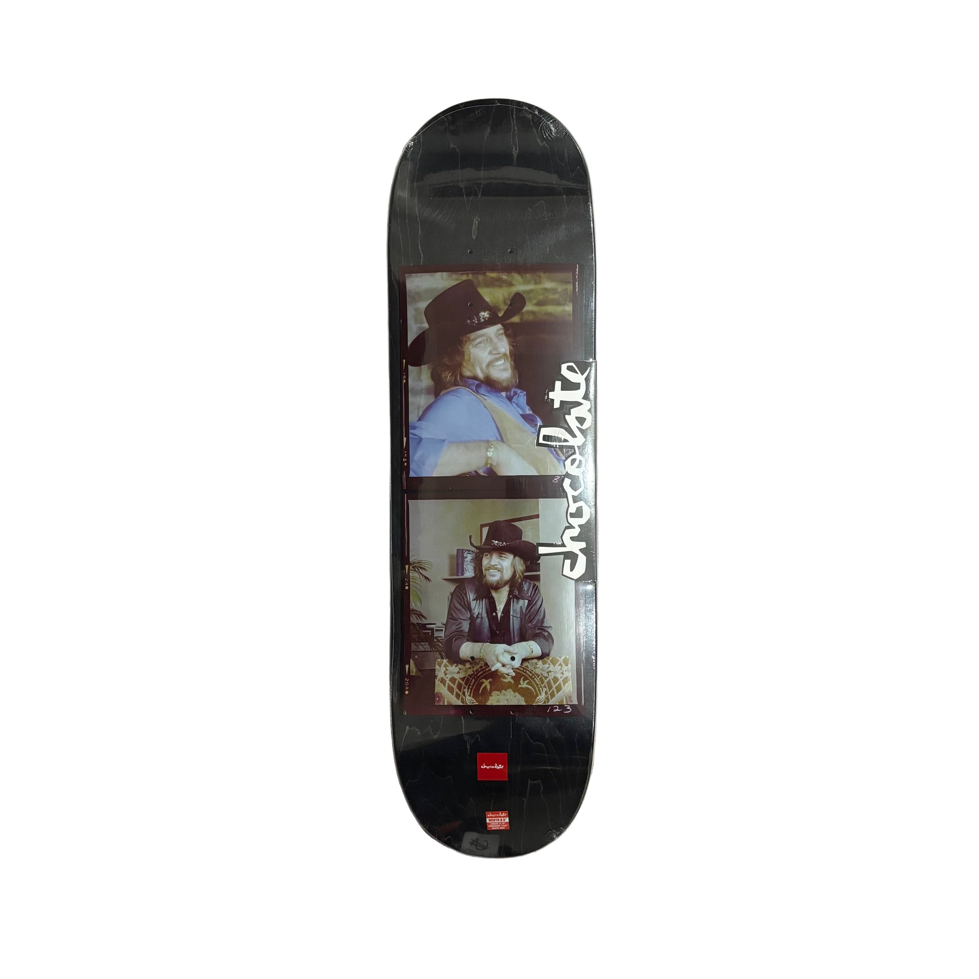 Skateboard deck with a cowboy graphic and 'Chocolate' branding on a white surface.