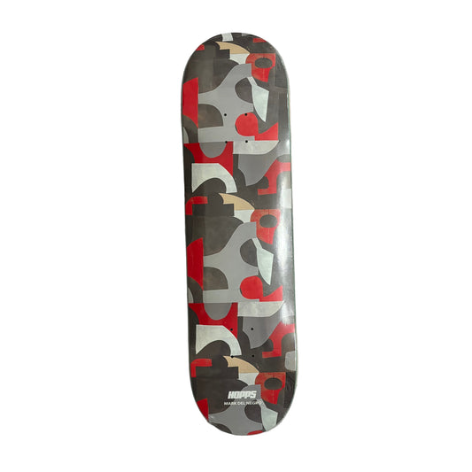 Skateboard deck with camouflage pattern on a white surface